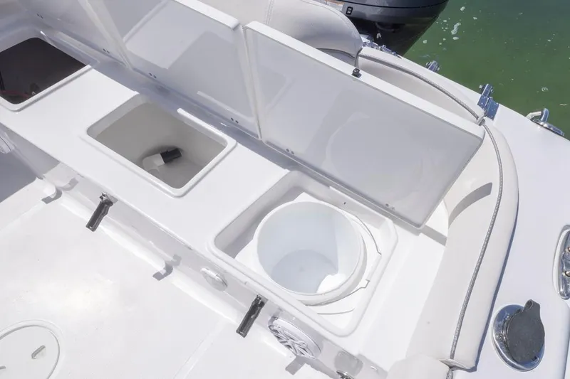 Slide: The Image of 2026 Sea Hunt Ultra 234 boat storage compartments and seating area. - 12