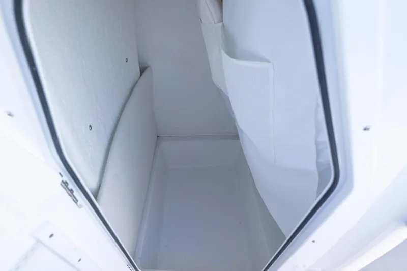 Slide: The Image of Interior storage compartment of 2026 Sea Hunt Ultra 234 boat, featuring white finish. - 15
