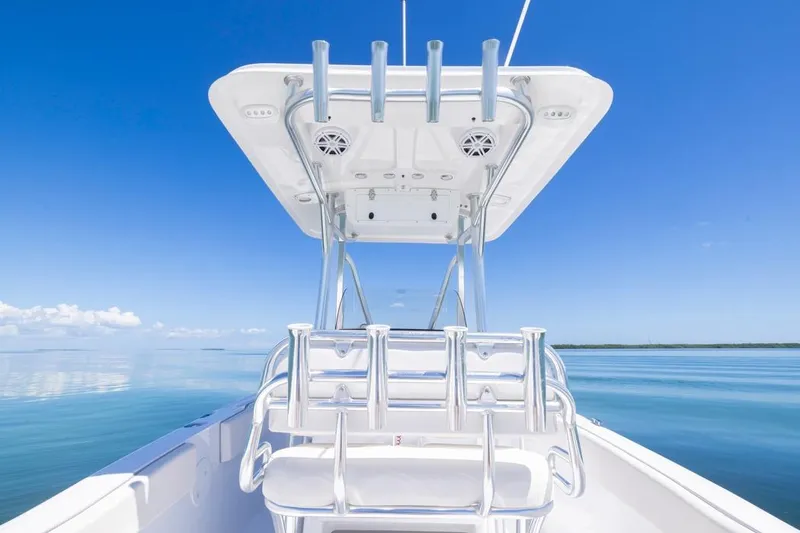 Slide: The Image of 2026 Sea Hunt Ultra 234 boat on calm blue water under clear sky. - 17
