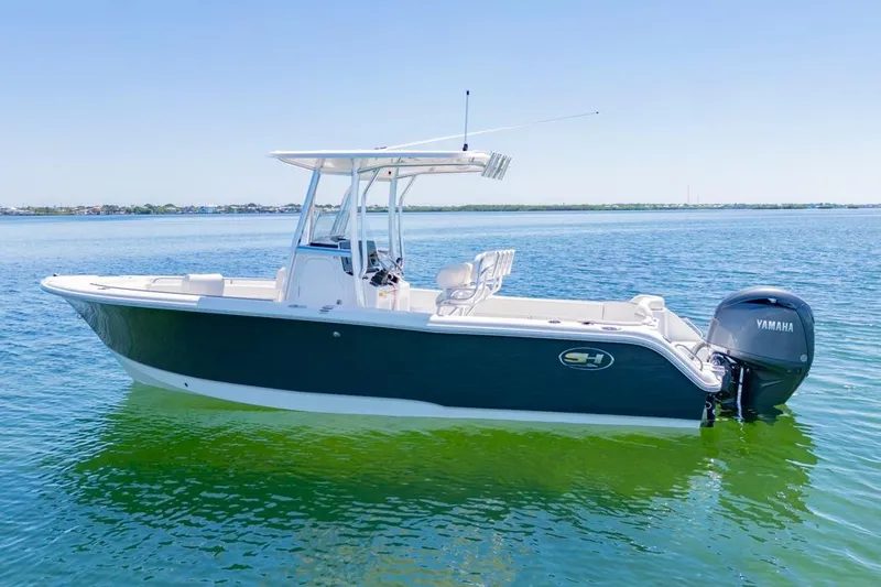 Slide: The Image of 2026 Sea Hunt Ultra 234 boat on calm water with Yamaha engine. - 18
