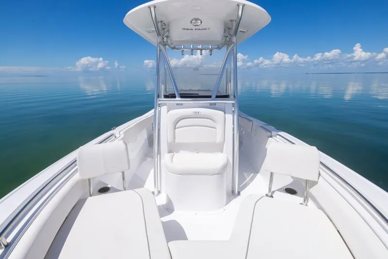 Slide: The Image of 2026 Sea Hunt Ultra 234 boat on calm ocean with clear blue sky. - 5