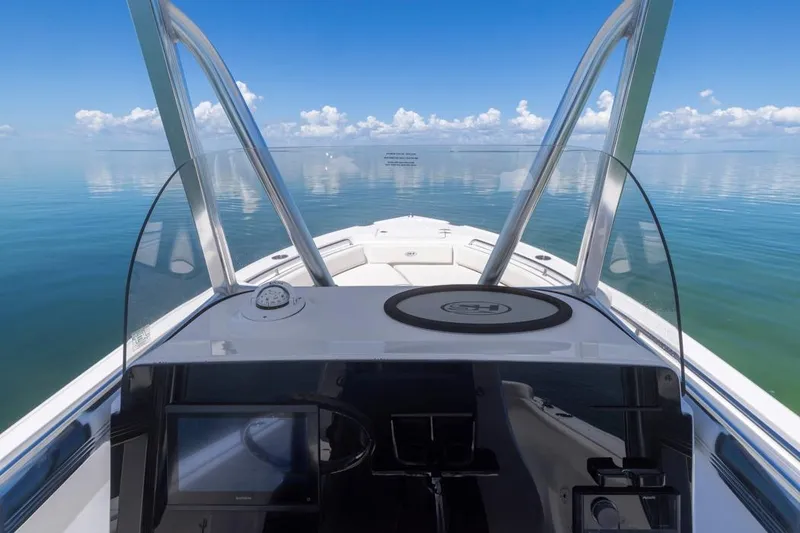 Slide: The Image of 2026 Sea Hunt Ultra 234 boat dashboard with ocean view and clear skies. - 7