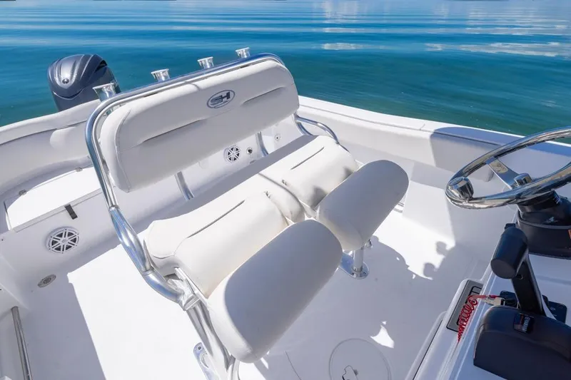 Slide: The Image of 2026 Sea Hunt Ultra 234 boat interior with white seating and steering wheel. - 9
