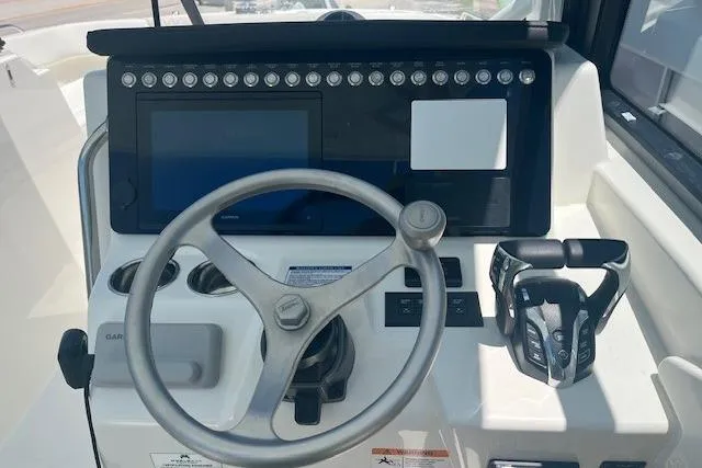 Slide: The Image of Helm of 2026 World Cat 265 DC-X boat with steering wheel and control panel. - 3