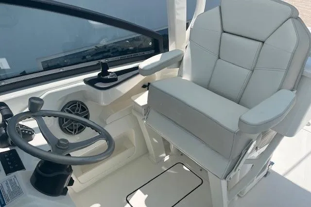 Slide: The Image of Helm of 2026 World Cat 265 DC-X boat with steering wheel and captain's chair. - 7