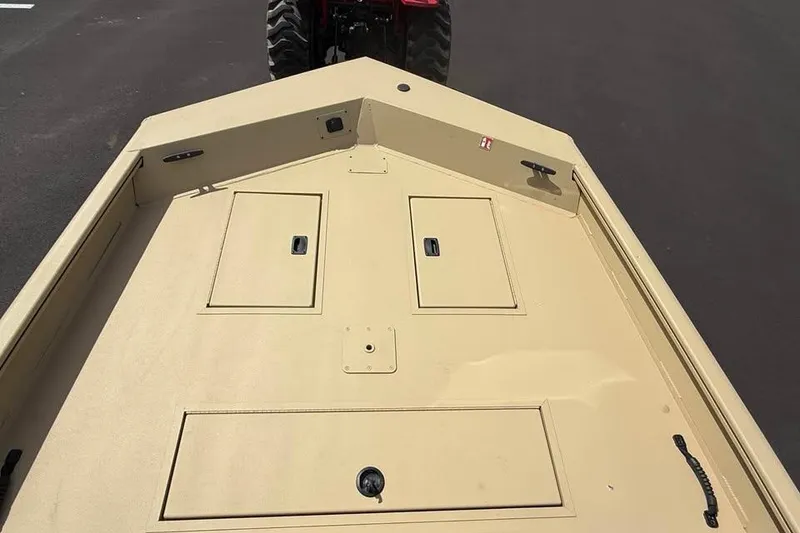 Slide: The Image of 2026 Crestliner 1870 Retriever FCC boat deck, beige color, with storage compartments. - 11