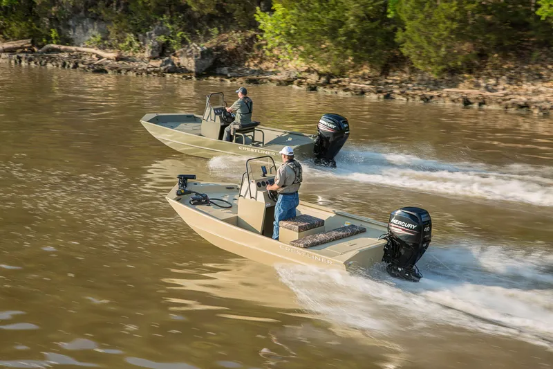 Slide: The Image of Two 2026 Crestliner 1870 Retriever FCC boats cruising on a river. - 14