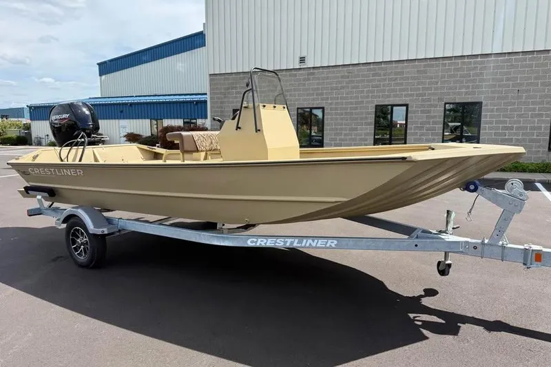 Slide: The Image of 2026 Crestliner 1870 Retriever FCC boat on trailer, parked outside industrial building. - 3