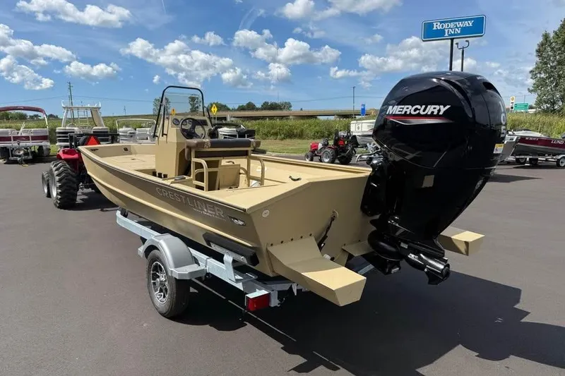 Slide: The Image of 2026 Crestliner 1870 Retriever FCC boat with Mercury engine on trailer, parked outdoors. - 5