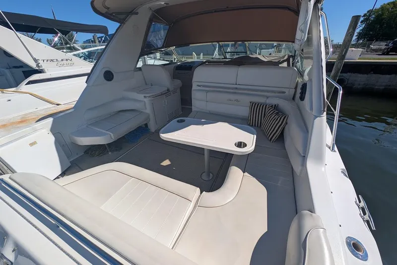 Slide: The Image of 1998 Sea Ray 370 Sundancer boat interior with seating and table, docked at marina. - 14