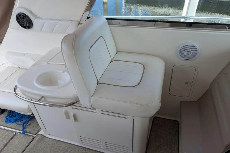 Slide: The Image of 1998 Sea Ray 370 Sundancer interior with white seating and cup holder, showcasing luxury design. - 19