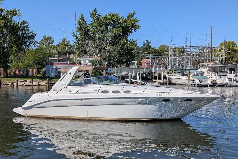 Slide: The Image of 1998 Sea Ray 370 Sundancer yacht docked in a marina on a sunny day. - 2