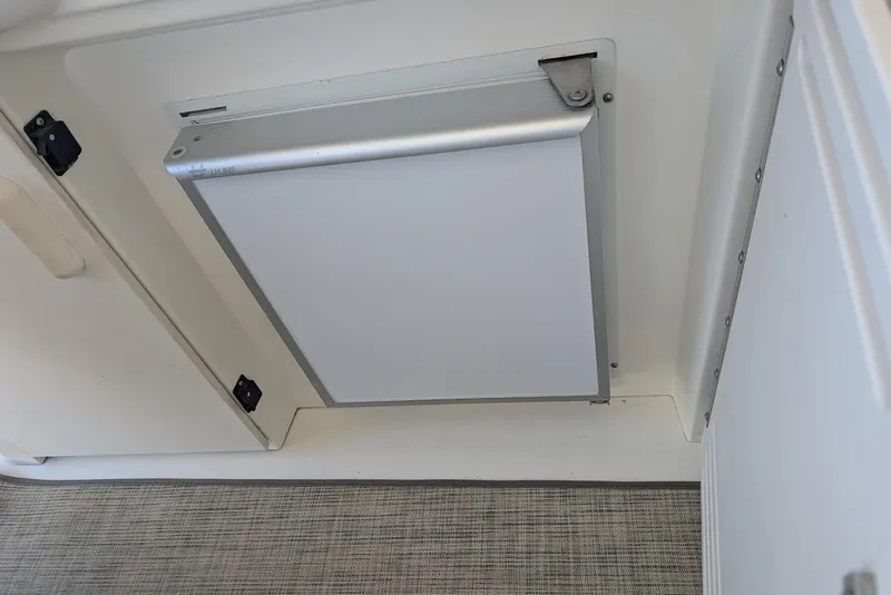 Slide: The Image of Built-in refrigerator on 1998 Sea Ray 370 Sundancer boat, featuring a sleek white panel. - 20