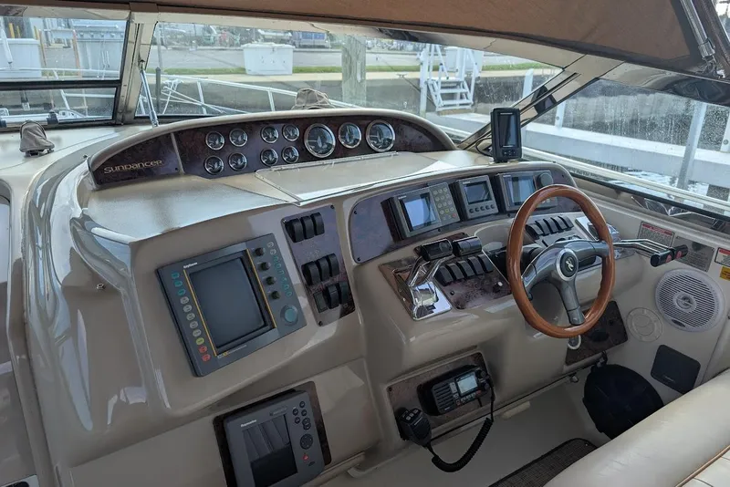Slide: The Image of 1998 Sea Ray 370 Sundancer helm with gauges, controls, and navigation equipment. - 22