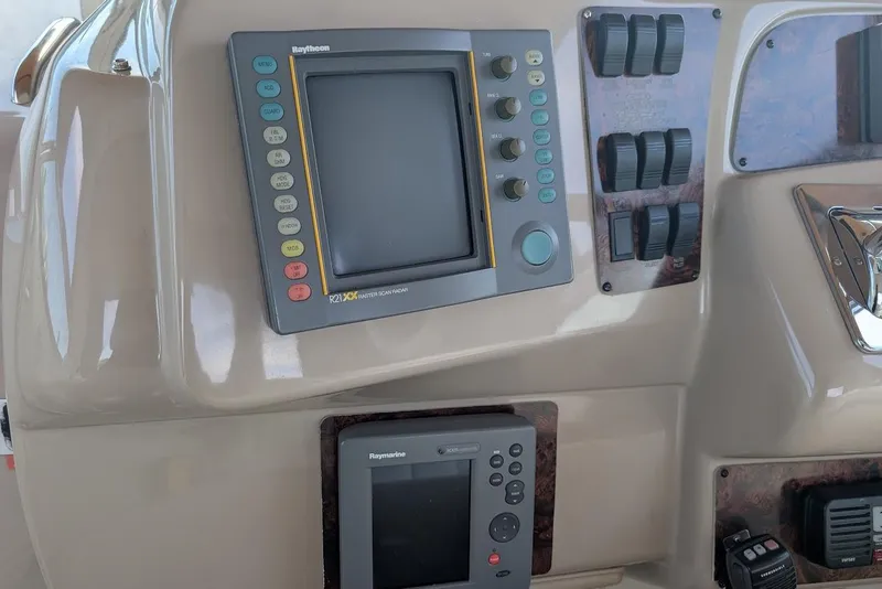 Slide: The Image of Control panel of a 1998 Sea Ray 370 Sundancer boat with navigation equipment. - 23