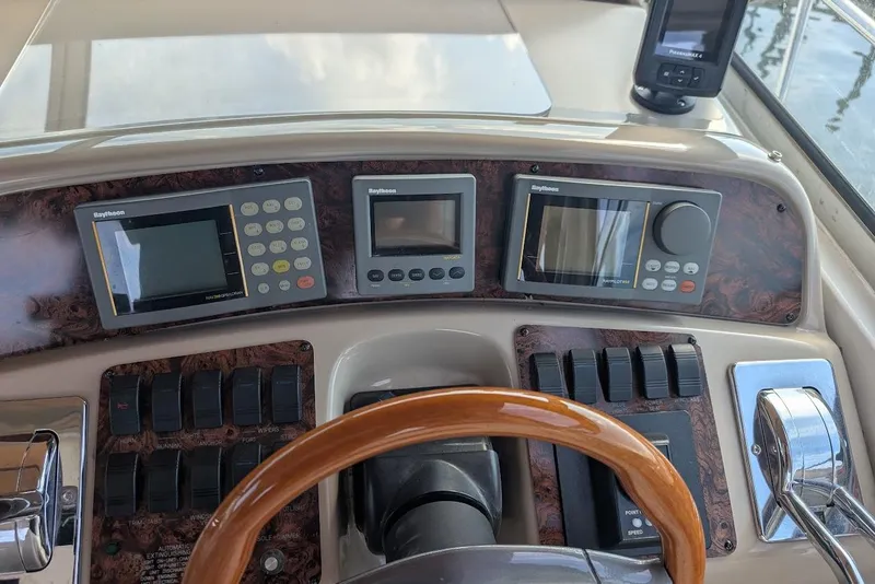 Slide: The Image of Control panel of a 1998 Sea Ray 370 Sundancer boat with navigation instruments. - 24