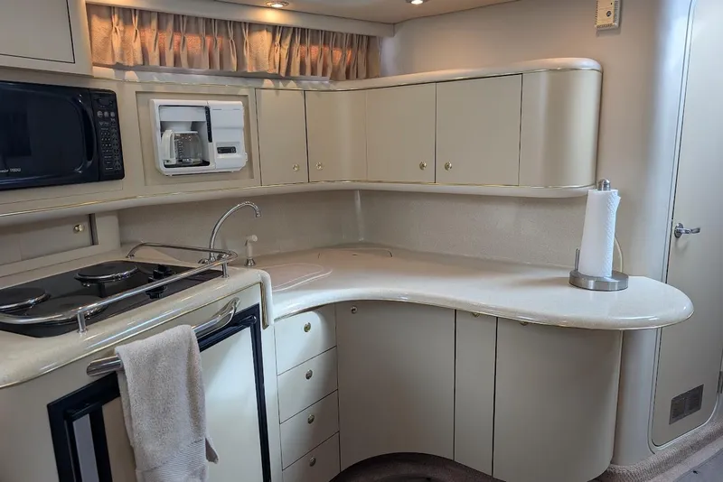 Slide: The Image of 1998 Sea Ray 370 Sundancer yacht kitchen with modern appliances and sleek cabinetry. - 28