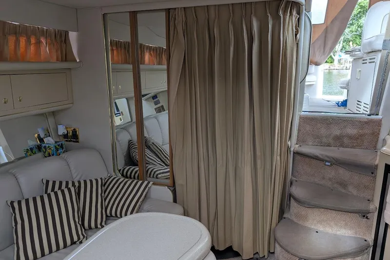 Slide: The Image of Interior of 1998 Sea Ray 370 Sundancer with cozy seating and striped cushions. - 38