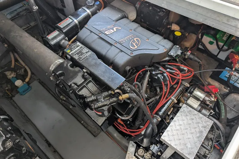 Slide: The Image of Engine compartment of a 1998 Sea Ray 370 Sundancer with visible V8 engine components. - 52