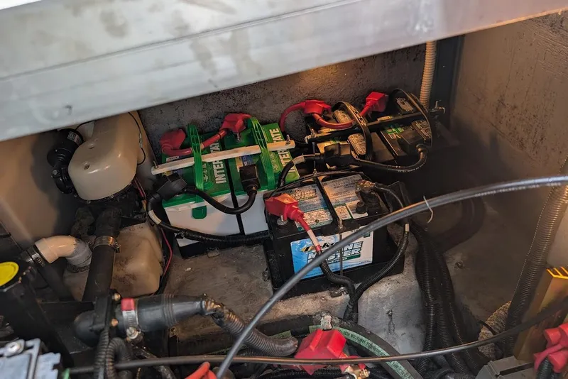 Slide: The Image of Battery compartment of a 1998 Sea Ray 370 Sundancer with multiple marine batteries. - 54