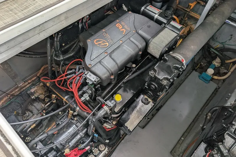 Slide: The Image of Engine compartment of a 1998 Sea Ray 370 Sundancer boat, showcasing detailed components. - 55