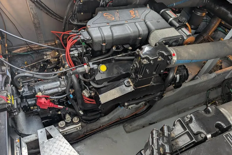 Slide: The Image of Engine compartment of a 1998 Sea Ray 370 Sundancer boat, showcasing detailed mechanical components. - 56
