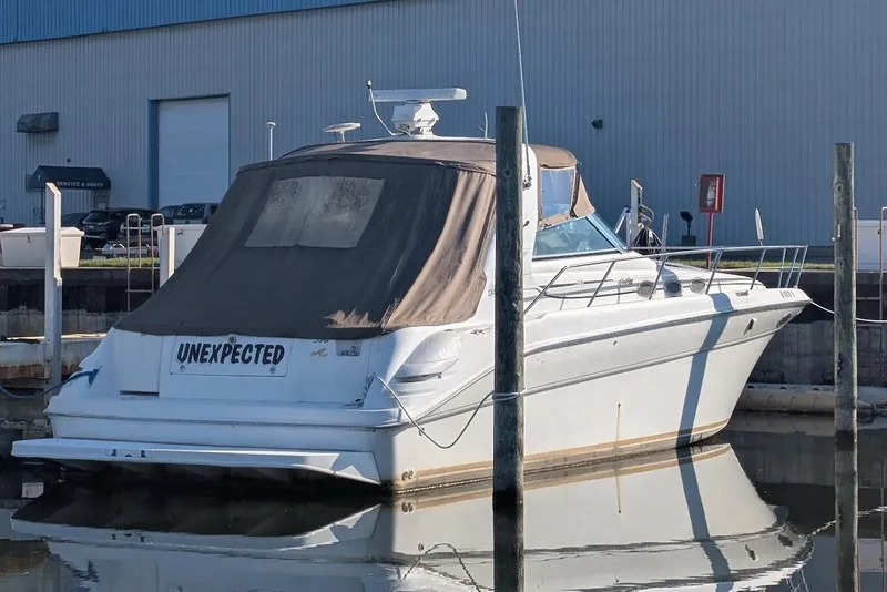 Slide: The Image of 1998 Sea Ray 370 Sundancer yacht docked at marina, rear view with cover. - 8