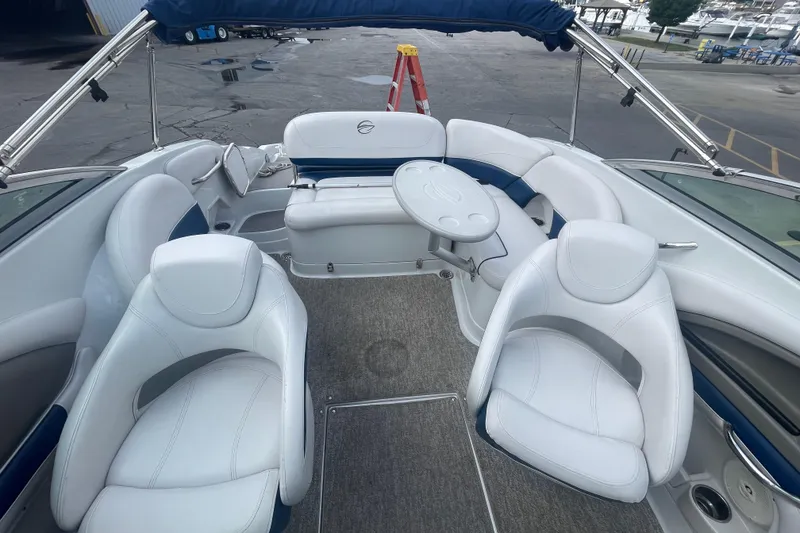Slide: The Image of 2012 Crownline Eclipse 2 boat interior with white seating and a round table. - 10