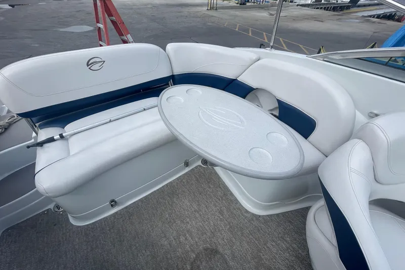 Slide: The Image of 2012 Crownline Eclipse 2 boat interior with white seating and a round table. - 11
