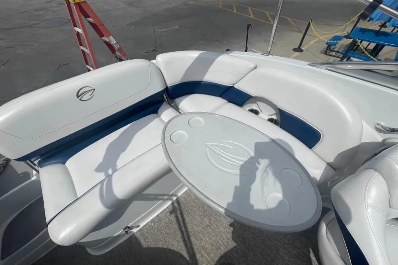 Slide: The Image of 2012 Crownline Eclipse 2 boat interior with white seating and oval table. - 12