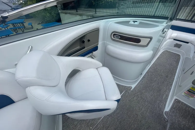 Slide: The Image of 2012 Crownline Eclipse 2 boat interior with white seating and carpeted flooring. - 13