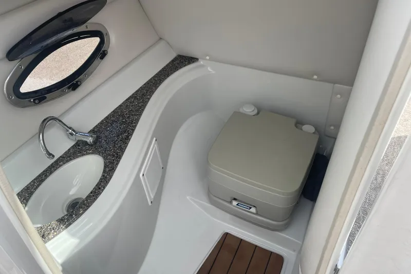 Slide: The Image of 2012 Crownline Eclipse 2 boat interior with sink and portable toilet. - 15