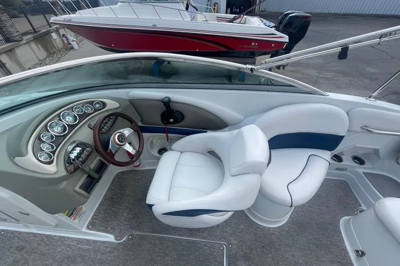 Slide: The Image of 2012 Crownline Eclipse 2 boat interior with steering wheel and white seating. - 16