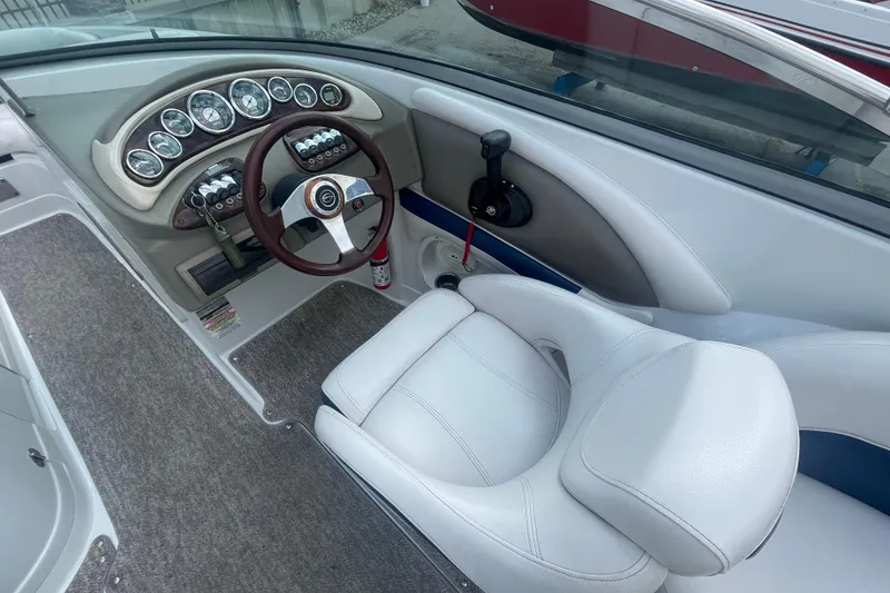 Slide: The Image of 2012 Crownline Eclipse 2 boat cockpit with steering wheel and gauges. - 17