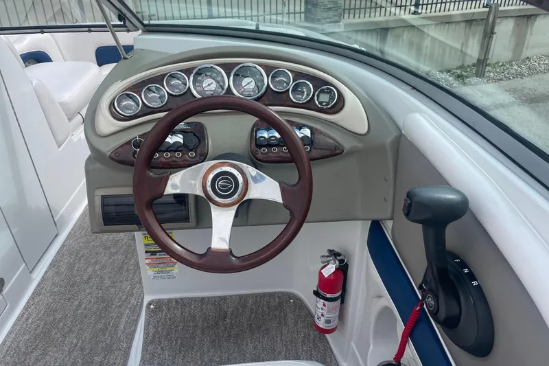 Slide: The Image of Steering console of a 2012 Crownline Eclipse 2 boat with gauges and controls. - 18