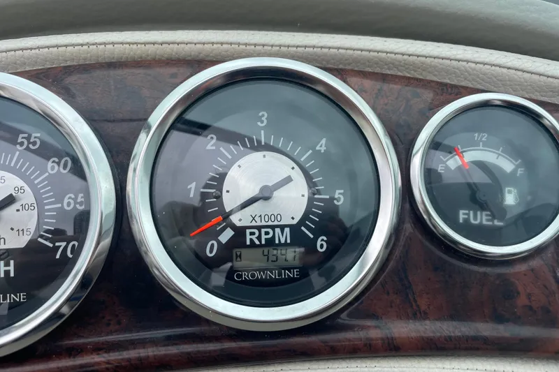 Slide: The Image of Dashboard of 2012 Crownline Eclipse 2 showing RPM and fuel gauges. - 27