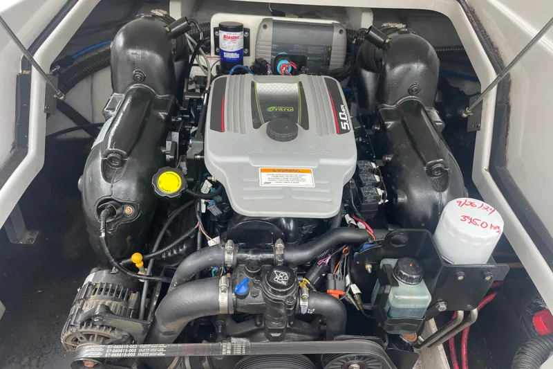 Slide: The Image of Engine compartment of a 2012 Crownline Eclipse 2 boat, featuring a 5.0L motor. - 29