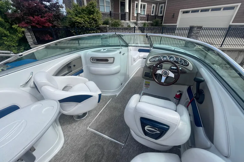 Slide: The Image of 2012 Crownline Eclipse 2 boat interior with white seating and modern dashboard. - 9