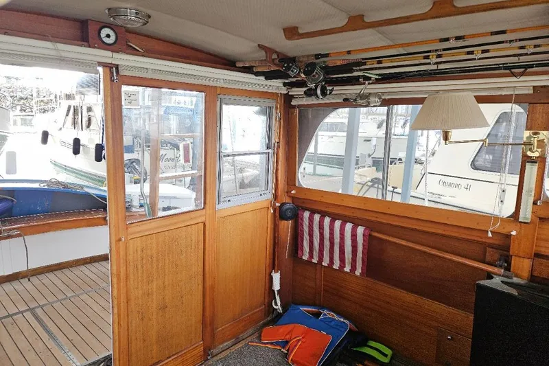 Slide: The Image of Interior of a 1968 Egg Harbor Sedan boat with fishing rods and nautical decor. - 10