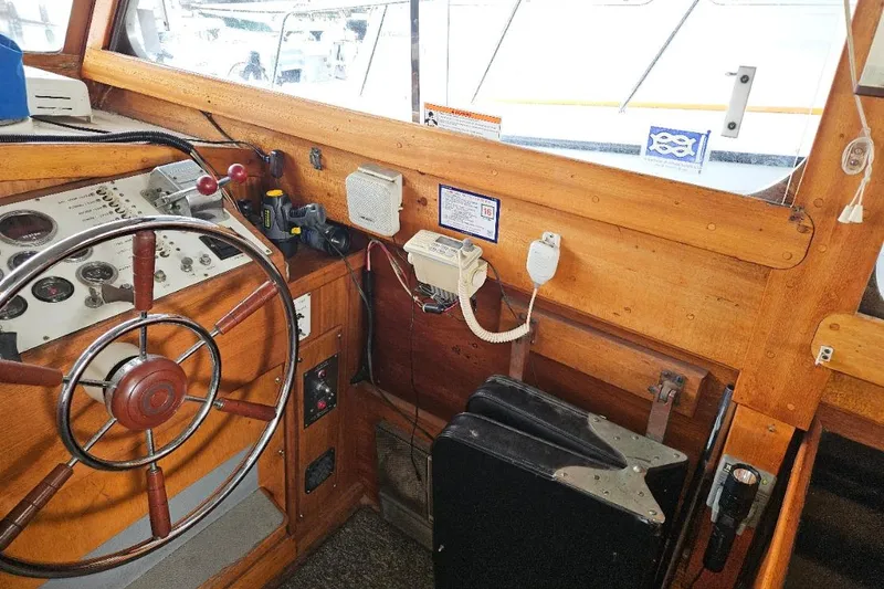 Slide: The Image of 1968 Egg Harbor Sedan helm with wooden steering wheel and vintage controls. - 12