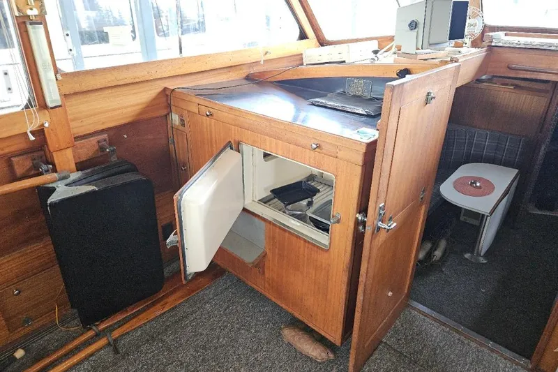 Slide: The Image of 1968 Egg Harbor Sedan interior with open wooden cabinet and small refrigerator. - 14