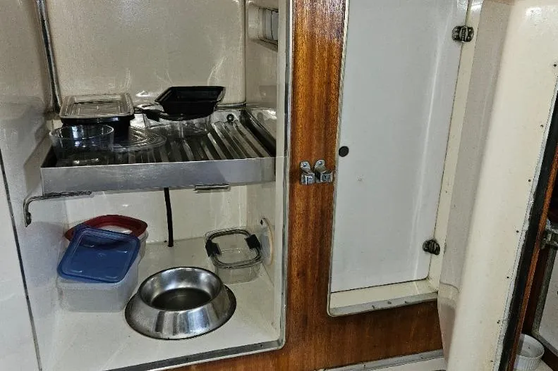 Slide: The Image of 1968 Egg Harbor Sedan kitchen storage with containers and metal bowl. - 16