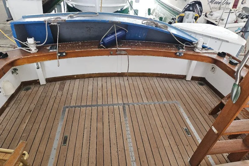 Slide: The Image of 1968 Egg Harbor Sedan boat deck with wooden flooring and nautical equipment. - 17
