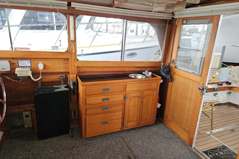 Slide: The Image of 1968 Egg Harbor Sedan interior with wooden cabinetry and nautical decor. - 3