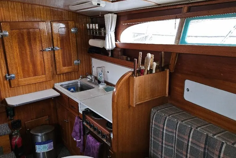 Slide: The Image of 1968 Egg Harbor Sedan interior with wooden cabinetry and compact kitchen area. - 4