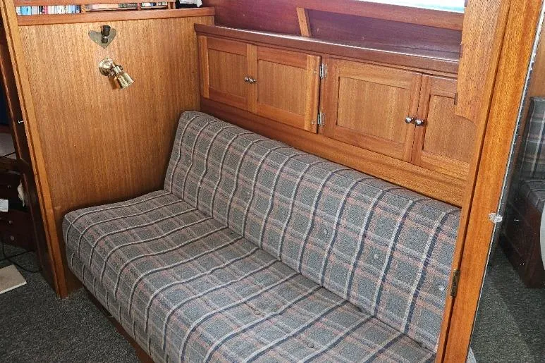 Slide: The Image of 1968 Egg Harbor Sedan interior with plaid sofa and wooden cabinets. - 7