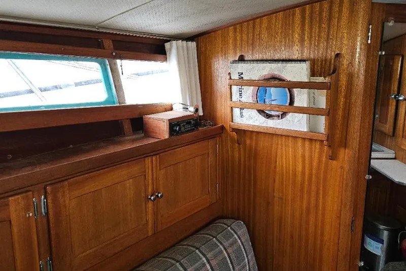 Slide: The Image of 1968 Egg Harbor Sedan interior with wooden cabinetry and nautical decor. - 8