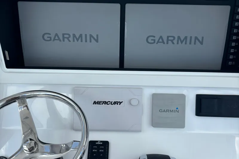 Slide: The Image of 2022 Onslow Bay 27 boat dashboard with Garmin displays and Mercury controls. - 3
