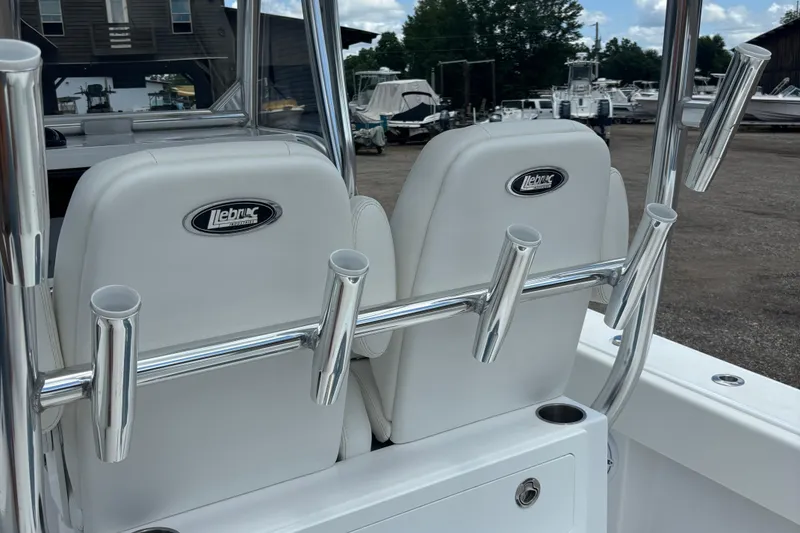 Slide: The Image of 2022 Onslow Bay 27 boat seats with rod holders, docked in a marina. - 4