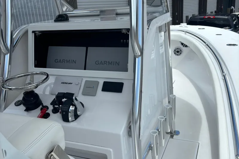 Slide: The Image of 2022 Onslow Bay 27 boat cockpit with Garmin displays and Mercury controls. - 7